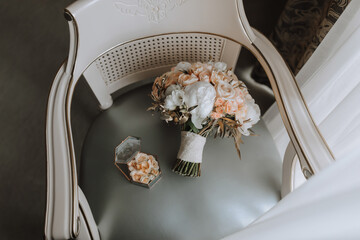 wedding bouquet of roses and various flowers on a chair in the wedding room