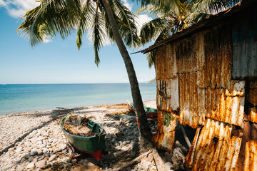 Ocean view with fishing hut and boats beached on shore, Scotts Head, Soufriere, Dominica, Caribbean - obrazy, fototapety, plakaty