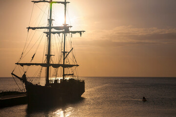 Silhouette of tall ship and people enjoying twilight, George Town, Cayman Islands, Caribbean