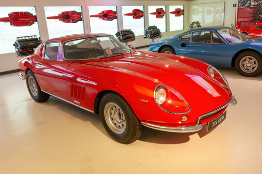 MODENA, ITALY &mdash; JULY 23, 2012: Museum Enzo Ferrari Modena. Red Ferrari 275 GTB 4 1966 with Ferrari horse, symbol of Ferrari on hood