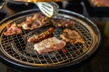 barbecue grilled on yakiniku stove which has hot charcoal. Barbecue Japanese style. Yakiniku. Is the Japanese version of Korean BBQ. Beef or Pork barbecue grilled on stove.