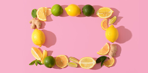Frame made of fresh lemons, limes and ginger on pink background. Banner for design