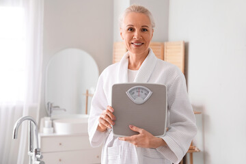 Mature woman with scales in bathroom