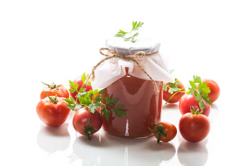 Cooked homemade tomato juice canned in a jar of natural tomatoes.