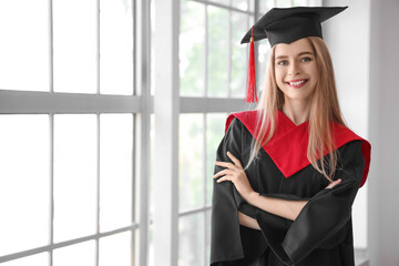 Female graduate student near window in room