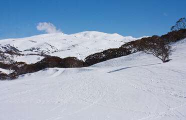 Fototapeta na wymiar Ski slopes and snowy hills in Perisher ski resort in winter in Australia