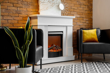 Stylish fireplace and armchairs in room