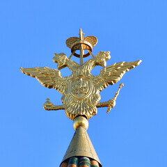 Double-headed eagle - coat of arms of the Russian Federation on the spire of Resurrection Gate in the Kremlin in Moscow, Russia