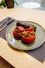 presentation of a lunch plate with cooked vegetables with rice, tomatoes and cooked aubergine.