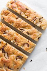 homemade onion focaccia on a white background, Flatlay of focaccia with red onion topping, fresh homemade focaccia bread