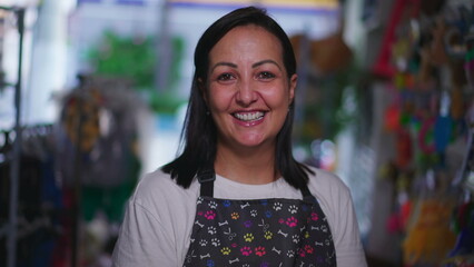 Happy female local Pet Shop owner smiling at camera portrat face close-up smiling inside Store...