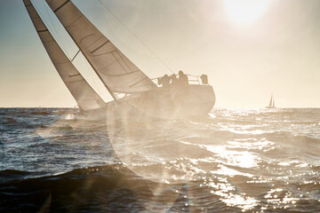 The view through the spray of how the sailboat is heeling at sunset, boat roll, splashes shine in...