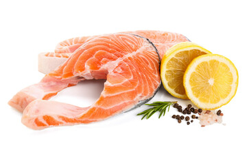 Raw salmon steaks and different spices on white background