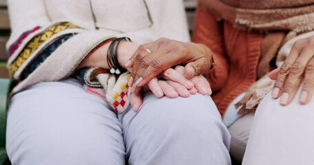 Senior friends, park care and holding hands with support, comfort and hope outdoor. Bench garden sitting and mature people with retirement, empathy and kindness gesture for friendship and trust