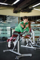 Fototapeta na wymiar elderly woman with short hair working out in gym, active, motivation, exercise machine, smile