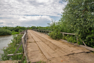 Fototapeta premium Old wooden bridge over Sluch river in Rivne region, Ukraine.