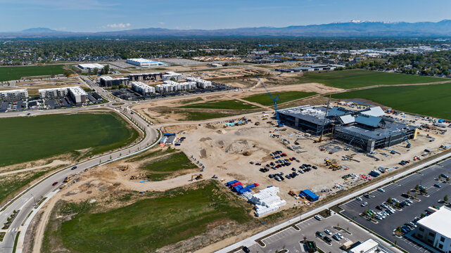 Commercial construction site with cranes, equipment, future developments, office buildings and apartments