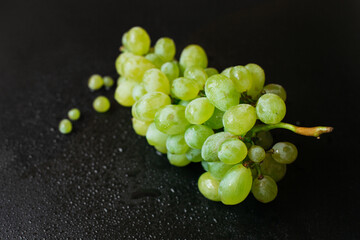 Grapes with water drops on black background
