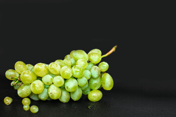 Grapes with water drops on black background