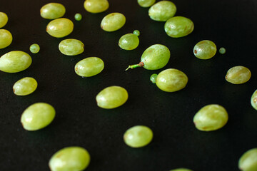 Abstract lying grapes on a black background