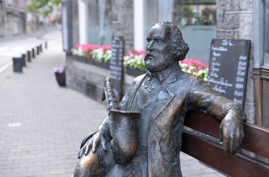 DINANT, BELGIUM – JULY 6, 2023: Bronze statue of Adolphe Sax, founder of the saxophone, in his hometown. Selective focus