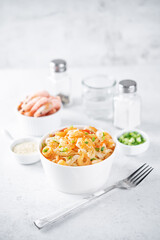 Funchosa with shrimp and vegetables in a plate Pad Thai