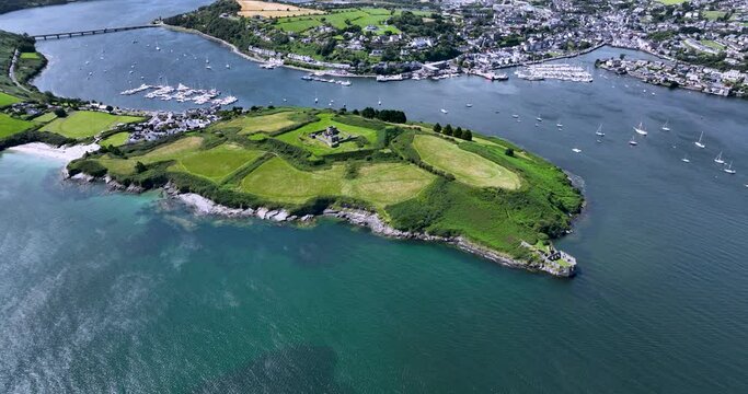 Aerial view of old ruin on a green island on a sunny day 4k
