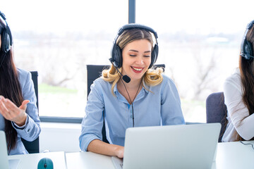Friendly telephone operator woman with headset having conversation with client, showing excellent...