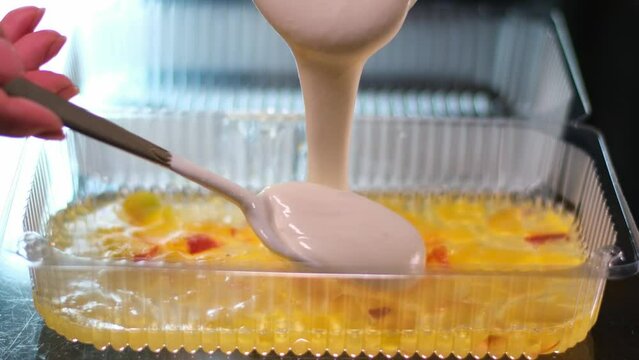 cooking jelly cakes with berries at home pour layers of delicious dessert beat in a blender. smooth with a tablespoon in a plastic container delicious dessert pour blueberry jelly mousse