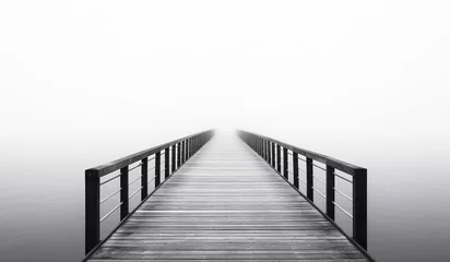 Fotobehang Wooden bridge in the fog over the sea. AI generated © Alicina