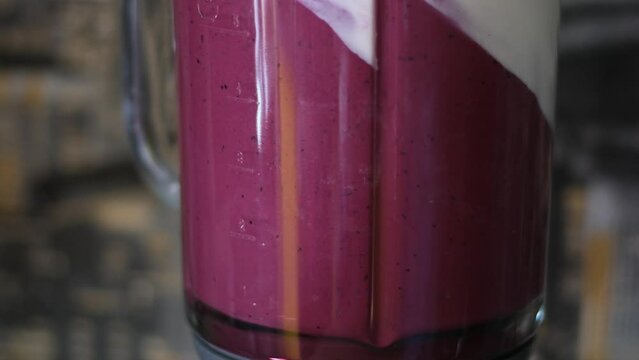 cooking jelly cakes with berries at home pour layers of delicious dessert beat in a blender. smooth with a tablespoon in a plastic container delicious dessert pour blueberry jelly mousse