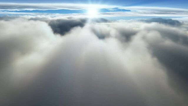 (Seamless loop) Flying through majectic clouds with the sun shining on the horizon. Dreaming of heavens and tranquility with rays of light and sunbeam