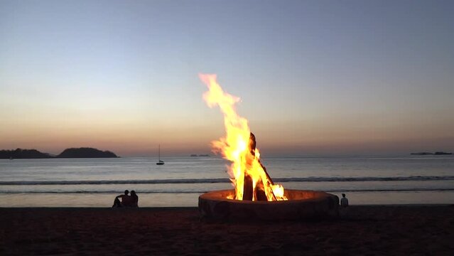 Playa Potrero Beach in Guanacaste Costa Rica Couple Watching Sunset With Bonfire