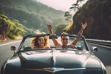 Fotobehang Happy couple driving on country road with raised hands. © Bojan