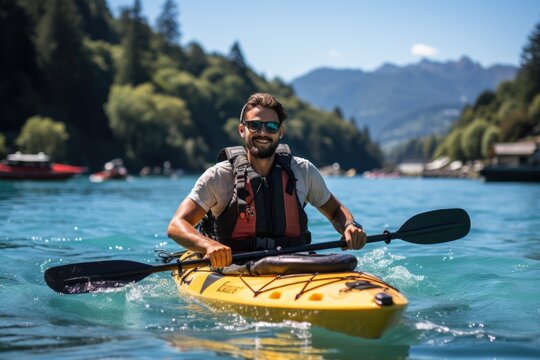 Man kayaking in a serene alpine lake - stock photography
