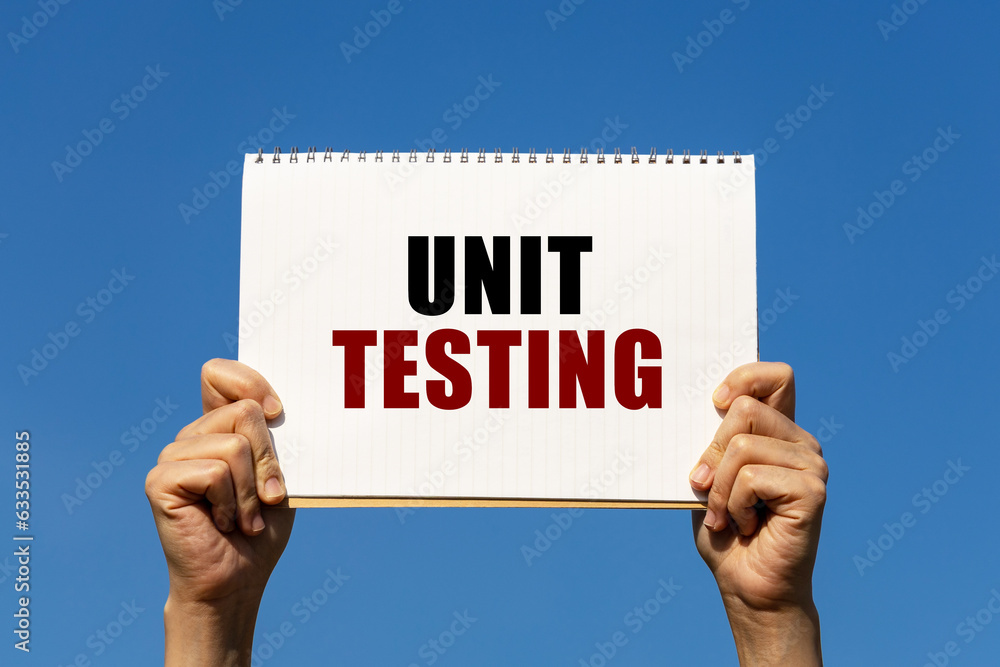 Poster unit testing text on notebook paper held by 2 hands with isolated blue sky background. this message 