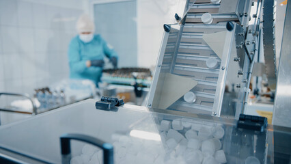 Feeding conveyor for transporting products to the filling and packaging machine. Transportation of products to the packaging machine. Production line of medical dietary supplements. Pharma factory