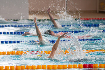 Race of backstroke swimmers in the pool