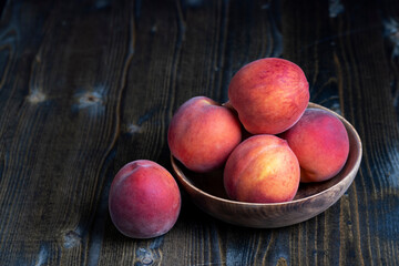 Ripe fresh peaches on a wooden table
