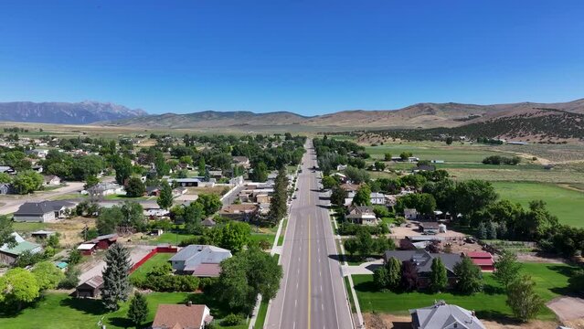 Fountain Green Utah rural city main street. Farming community agricultural economy. Spring summer weather mountain valley green agriculture field. Homes, barns and buildings.