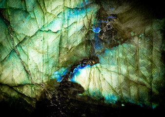 This is a macro photo of a colorful blue and green labradorite stone.  I used special lighting to bring out the iridescent colors and cracked mineral textures.