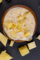 milk pineapple yogurt with pieces of pineapple and other fruits
