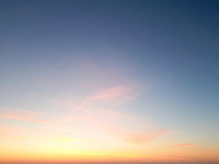 Amidst a serene backdrop, the dawn breaks, painting the horizon in myriad shades of pink. A drone captures this breathtaking ballet of nature from a bird's-eye perspective, 