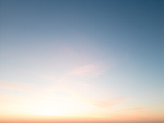 Amidst a serene backdrop, the dawn breaks, painting the horizon in myriad shades of pink. A drone captures this breathtaking ballet of nature from a bird's-eye perspective, revealing the world awakeni