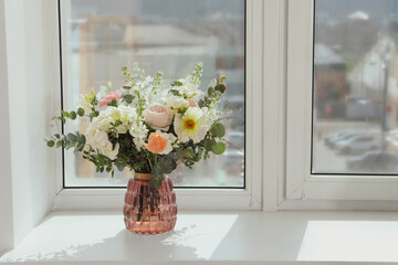 Bouquet of beautiful flowers on windowsill indoors. Space for text