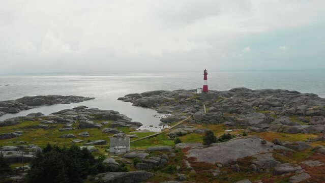 drone flies over lighthouse on norwegian south coast Eigeroy Fyr