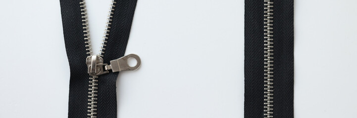 Zipped and unzipped metallic zipper lock on white background. © megaflopp