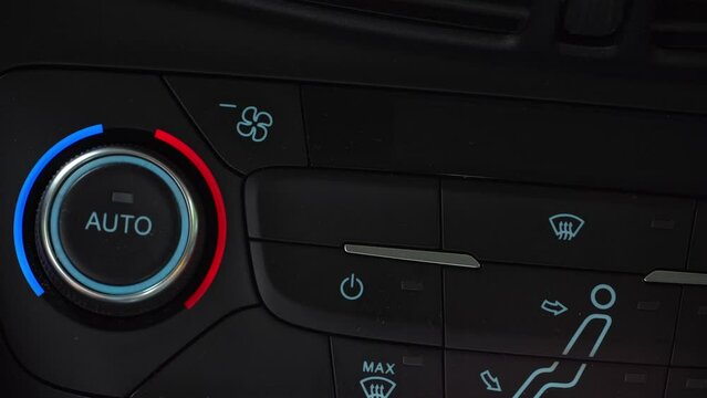 Finger turning off toggle switch of car air conditioner, two-phase climate control in the car