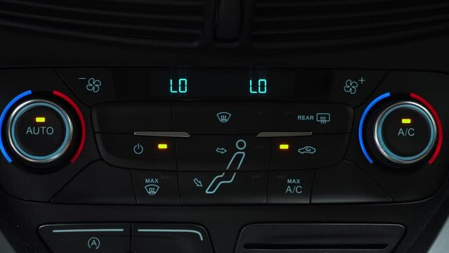 Finger presses button for turn on air recirculation mode in passenger compartment, two-phase climate control in the car