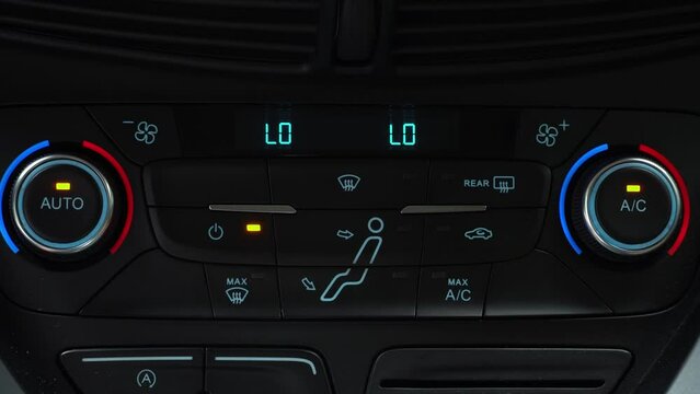Finger presses button for turn off air recirculation mode in passenger compartment, two-phase climate control in the car
